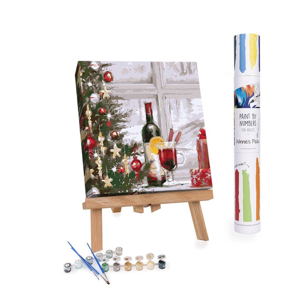 Paint by numbers kit with Christmas scene on easel and paint canisters.