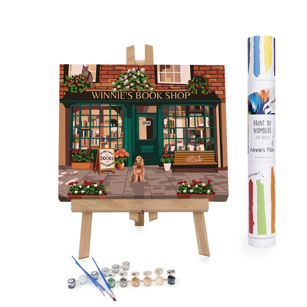 Paint by numbers kit with an easel and paint supplies, featuring a bookshop scene.