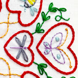 Embroidery with butterflies and flowers on a white background