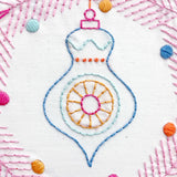 Embroidered ornament design with colorful thread on a white background