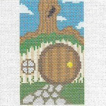 Needlepoint canvas design of a hobbit hole home in a grassy field