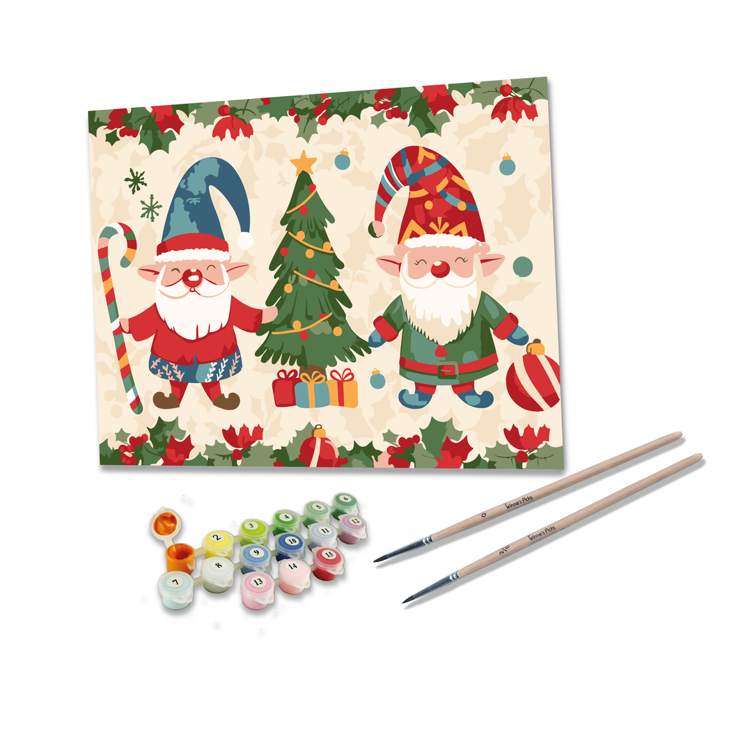 Christmas-themed painting set with two gnomes, a tree, and presents on a card, accompanied by paintbrushes and small bottles of paint.