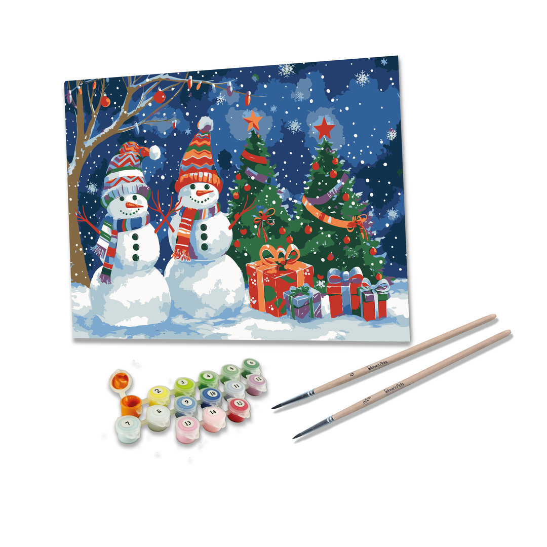 Painting kit with snowmen, Christmas tree, and presents on a snowy scene, accompanied by paint bottles and brushes.