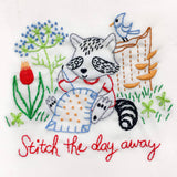 Embroidery design of a raccoon with flowers and text 'Stitch the day away' on a white background