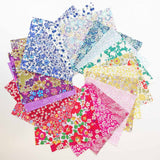 Collection of colorful floral fabric samples on a white background