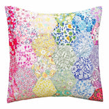 Multicolored floral and patterned pillow on a white background