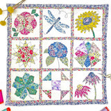 Colorful quilt with floral and nature-themed blocks on a white background