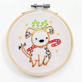 Embroidery hoop with a dog design on white fabric