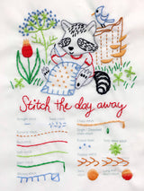 Embroidery design with a raccoon, flowers, and text 'Stitch the day away' on a white background.