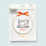 Embroidery craft kit with vintage sewing machine design on a light blue background