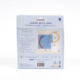 DMC embroidery kit packaging with text and images on a white background