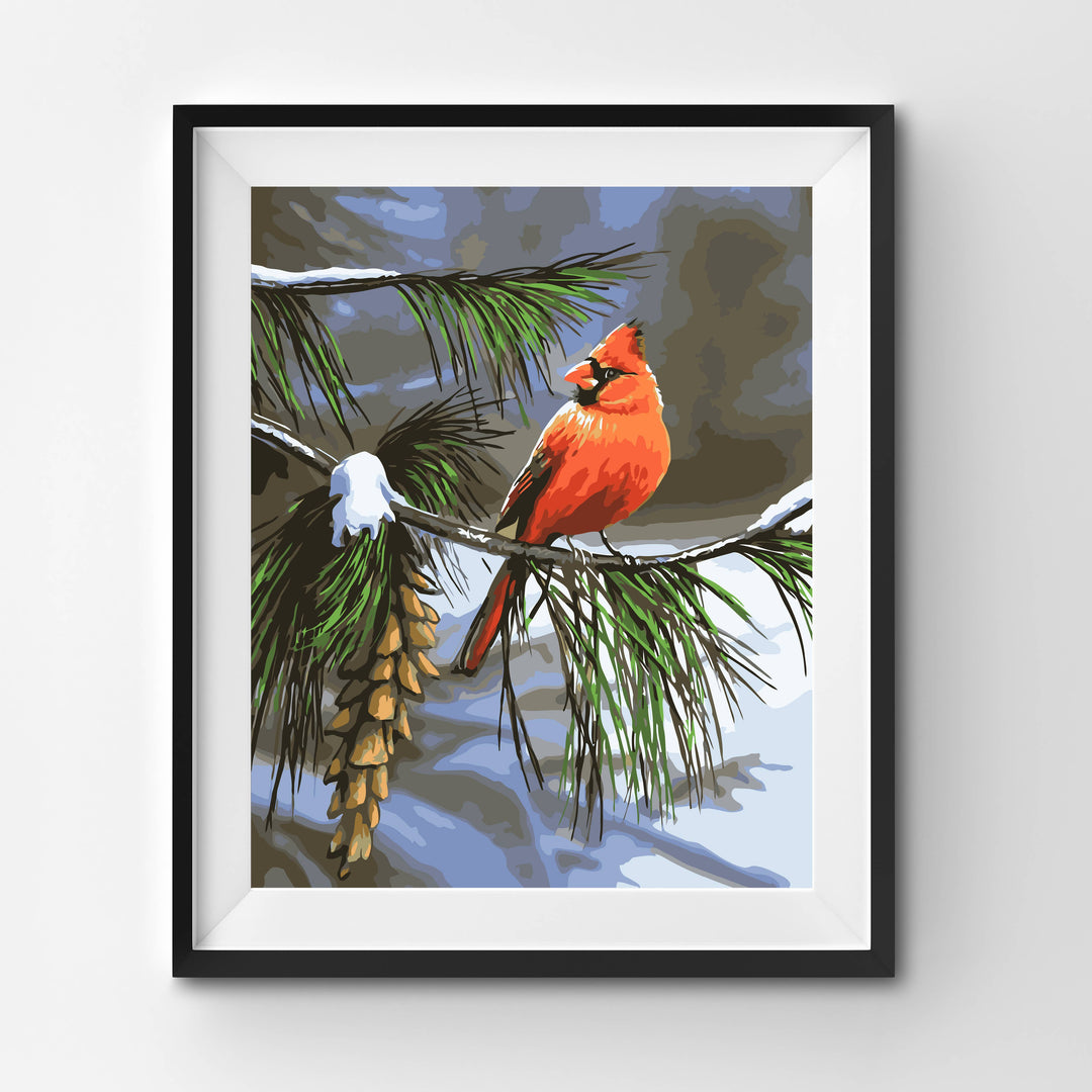 Framed artwork of a red cardinal bird on a branch with pinecones and snow.