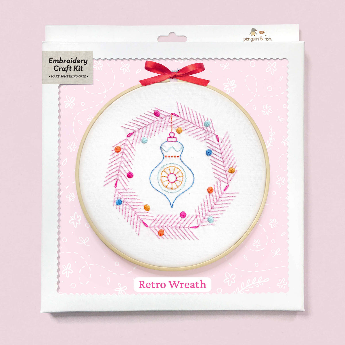 Embroidery craft kit with retro wreath design on a pink background