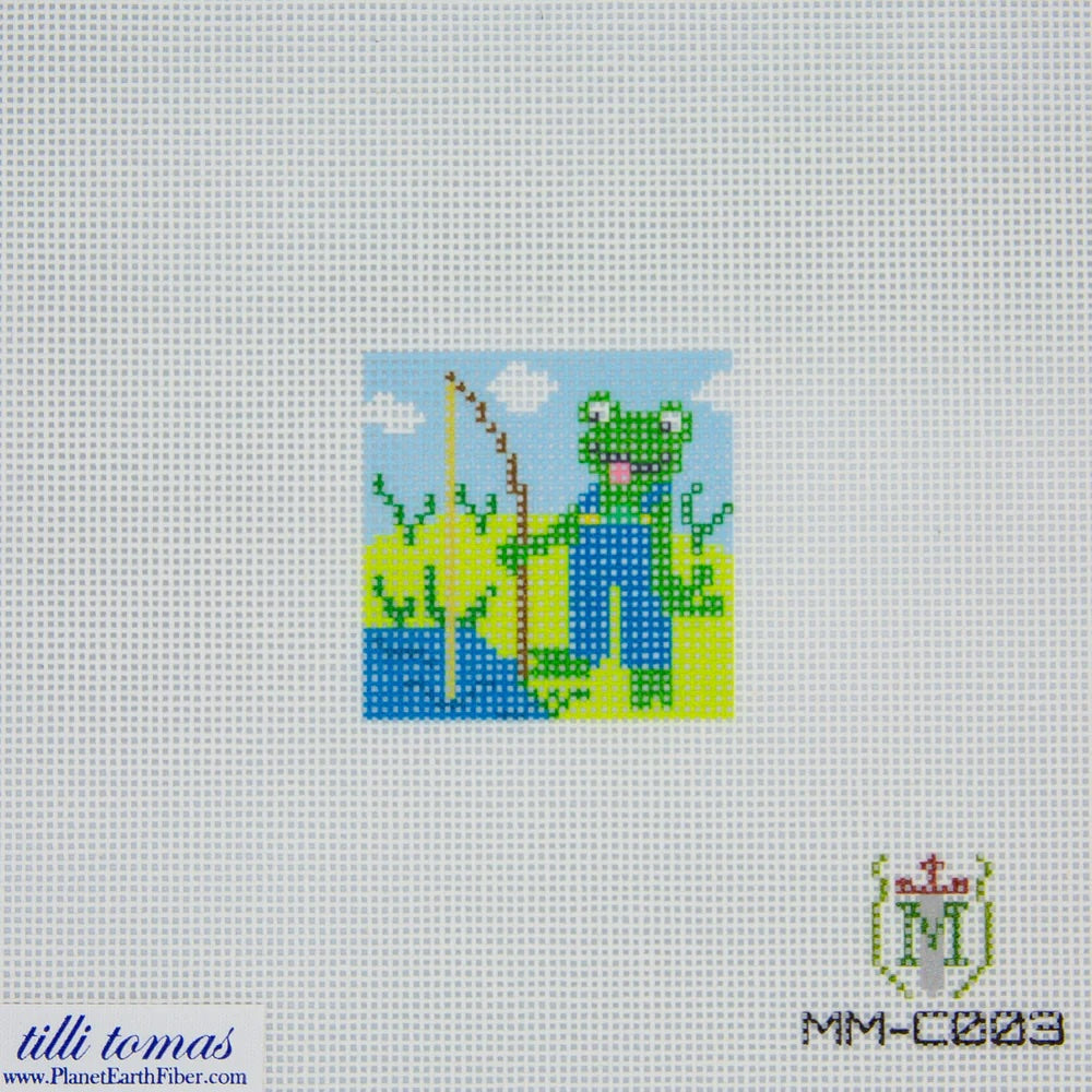 Needlepoint canvas design of a frog with overalls on a white fabric background