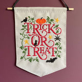 Embroidered banner with 'Tricks or Treat' text on a purple background
