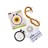 Embroidery kit with hoop, thread, and pattern on a white background