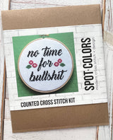 Cross stitch kit with hoop and printed design on a cardboard backing