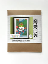 Counted cross stitch kit packaging with a cartoon frog design on a white background