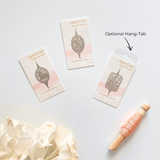 Three packages of Eightfold Crafts lace roller with an optional hang-tab on a light gray background.