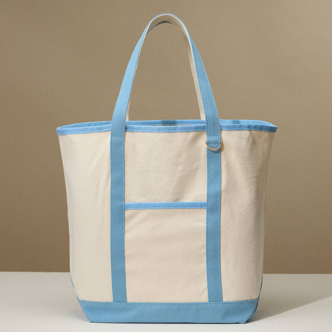 Beige tote bag with blue accents on a beige background