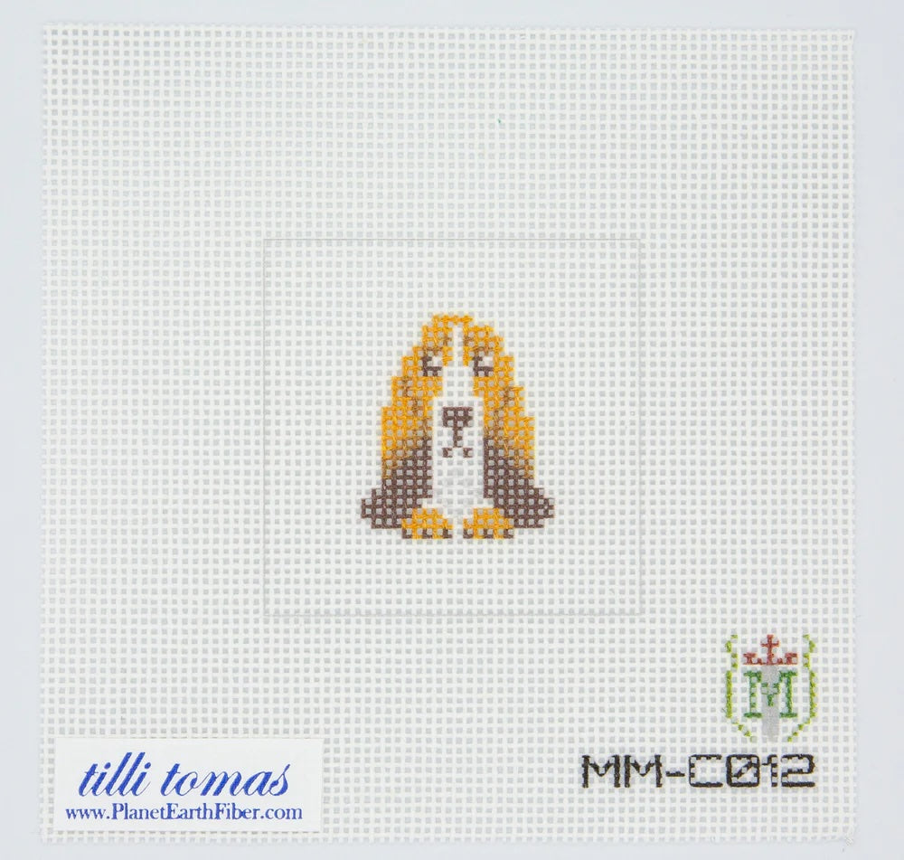 Needlepoint canvas dog pattern on fabric with 'tilli tomas' branding.