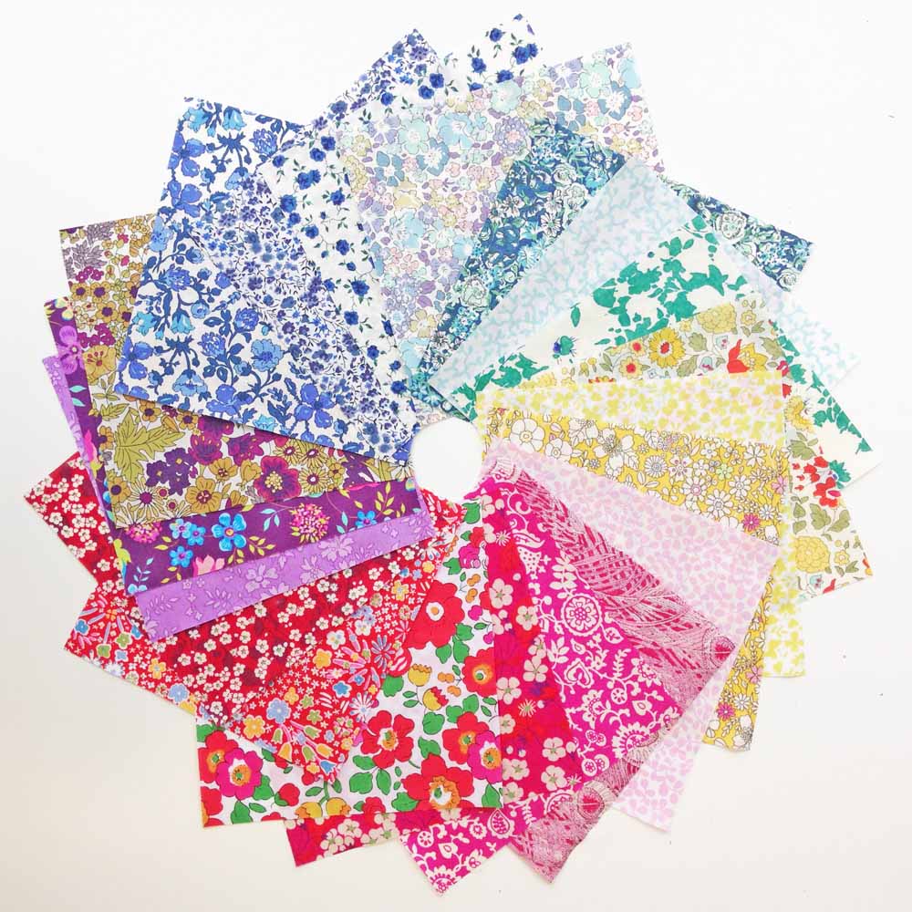 Collection of colorful floral fabric samples on a white background