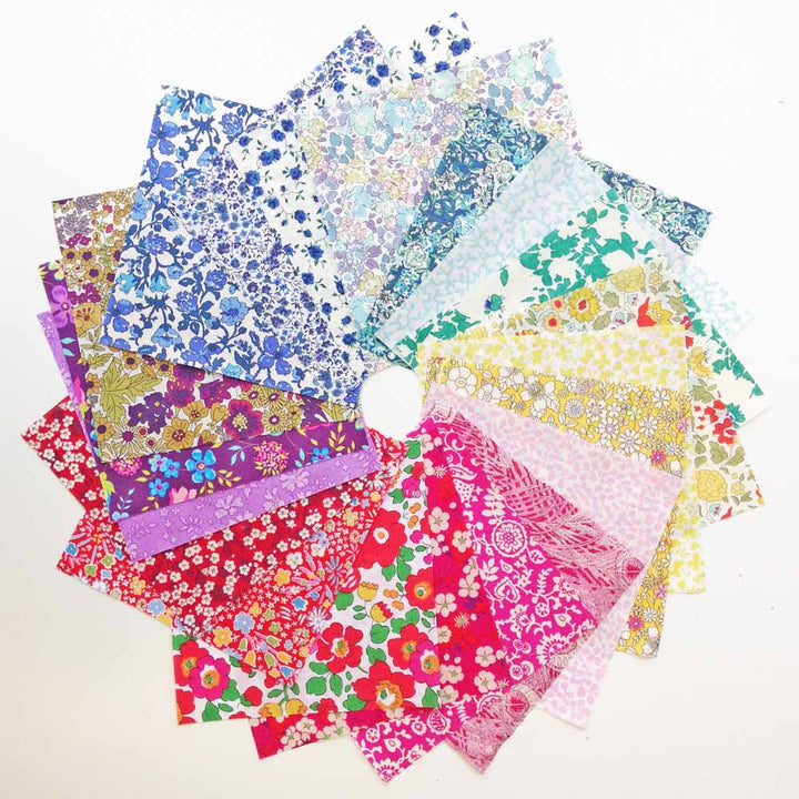 Collection of colorful floral fabric samples on a white background