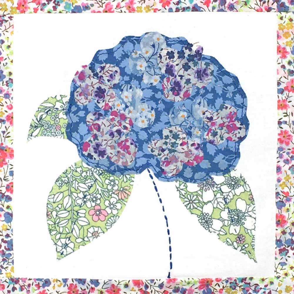 Floral patterned fabric with a blue flower design on a white background