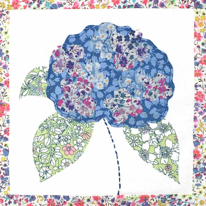 Floral patterned fabric with a blue flower design on a white background