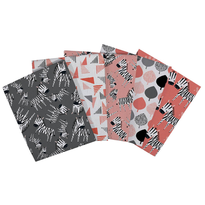 Set of four patterned notebooks with zebra and abstract designs on a white background