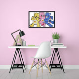 Framed artwork of three colorful bears on a pink wall above a desk with a white chair.
