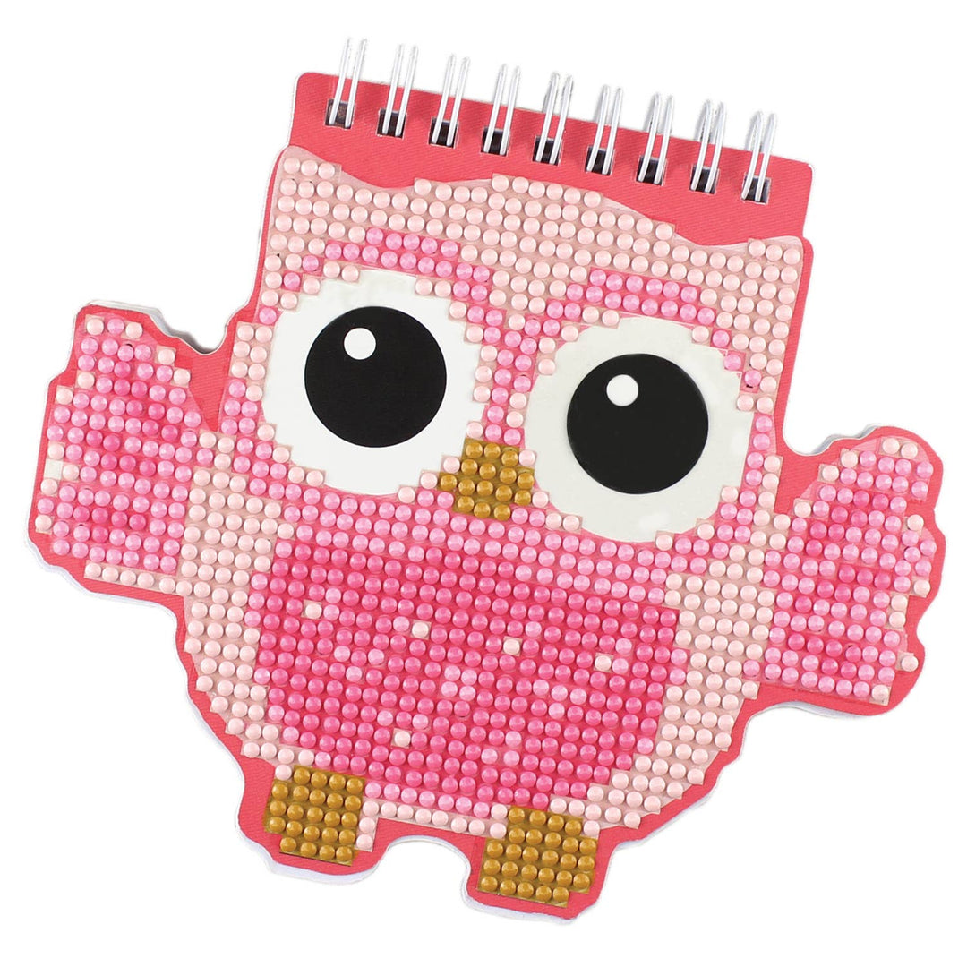 Pink owl-shaped notebook with beaded design on a white background