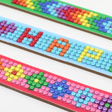 Colorful beaded bracelets with letters on a white background
