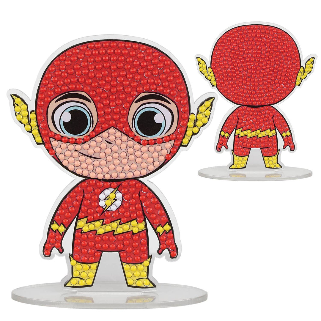 Decorative figurine of a superhero character with red costume and yellow accents on a white background
