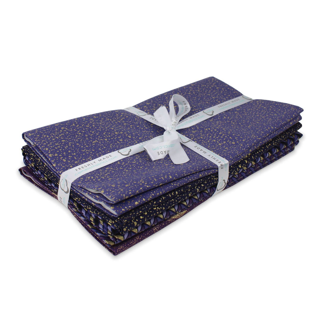 Purple fabric with gold speckles and a white ribbon on a white background