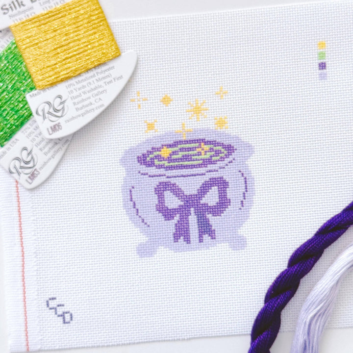 Cotswold Co Designs - Magic Cauldren Halloween Needlepoint Canvas, 18 mesh, 4x4” design, modern trendy needlepoint canvas, bow Halloween needlepoint - Pisgah Needleworks