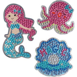 Set of three decorative stickers featuring a mermaid, an octopus, and a shell with bead patterns on a white background.