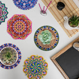Colorful mandala coasters with succulents on a white surface