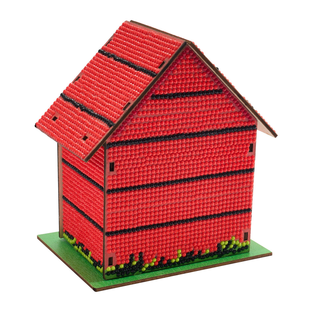 Model of a red building with a green base on a white background