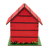 Red model house with a green base on a white background