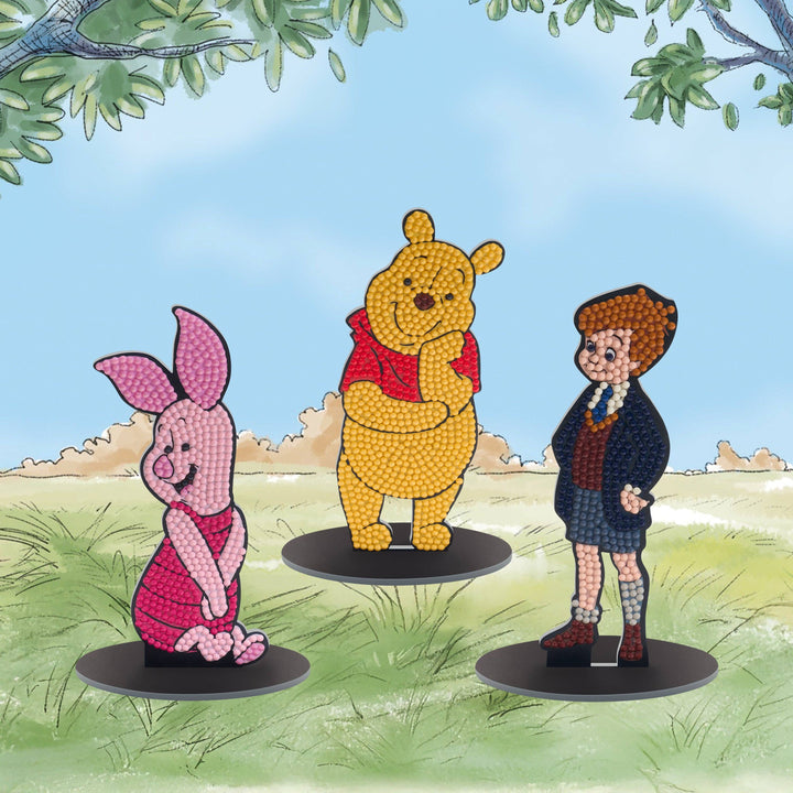 Decorative figurines of a bear, piglet, and owl against a nature-themed background