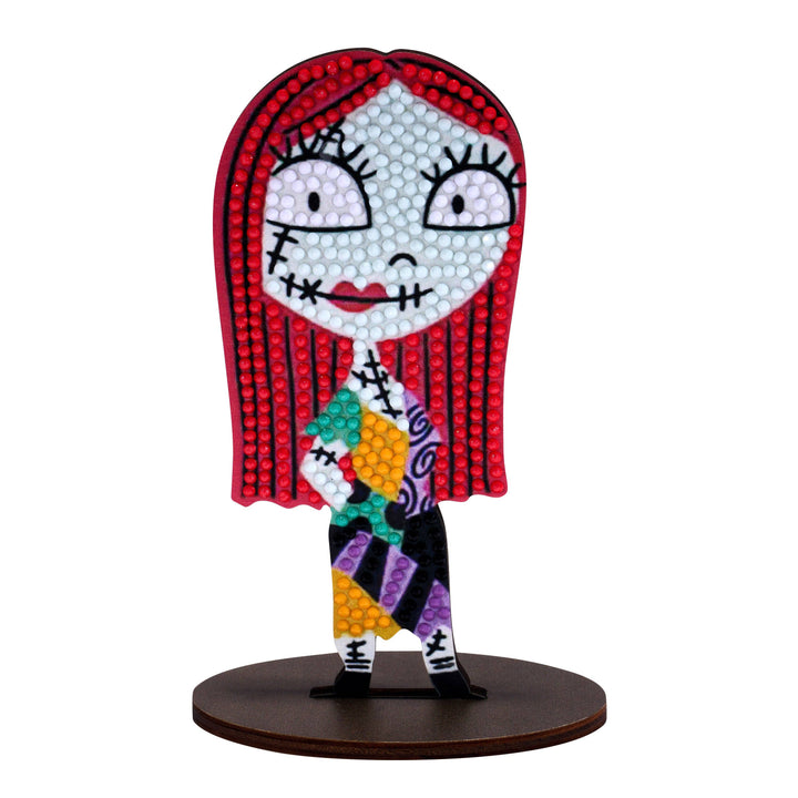 Colorful figurine with red hair and multicolored outfit on a white background