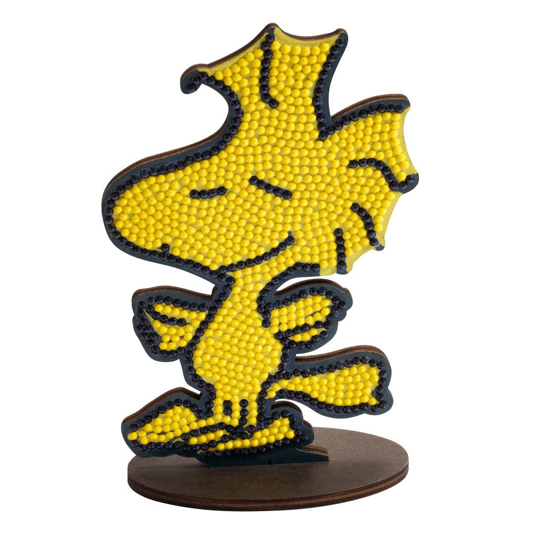 Yellow dog figurine with black outline on a white background