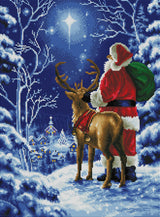 Cross-stitched scene of Santa Claus with a reindeer in a snowy landscape