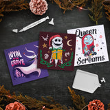 Three embroidered cards with festive designs on a dark surface with decorative elements.
