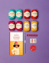 Set of colorful yarn balls with a book titled 'Kith & Kin' on a purple background