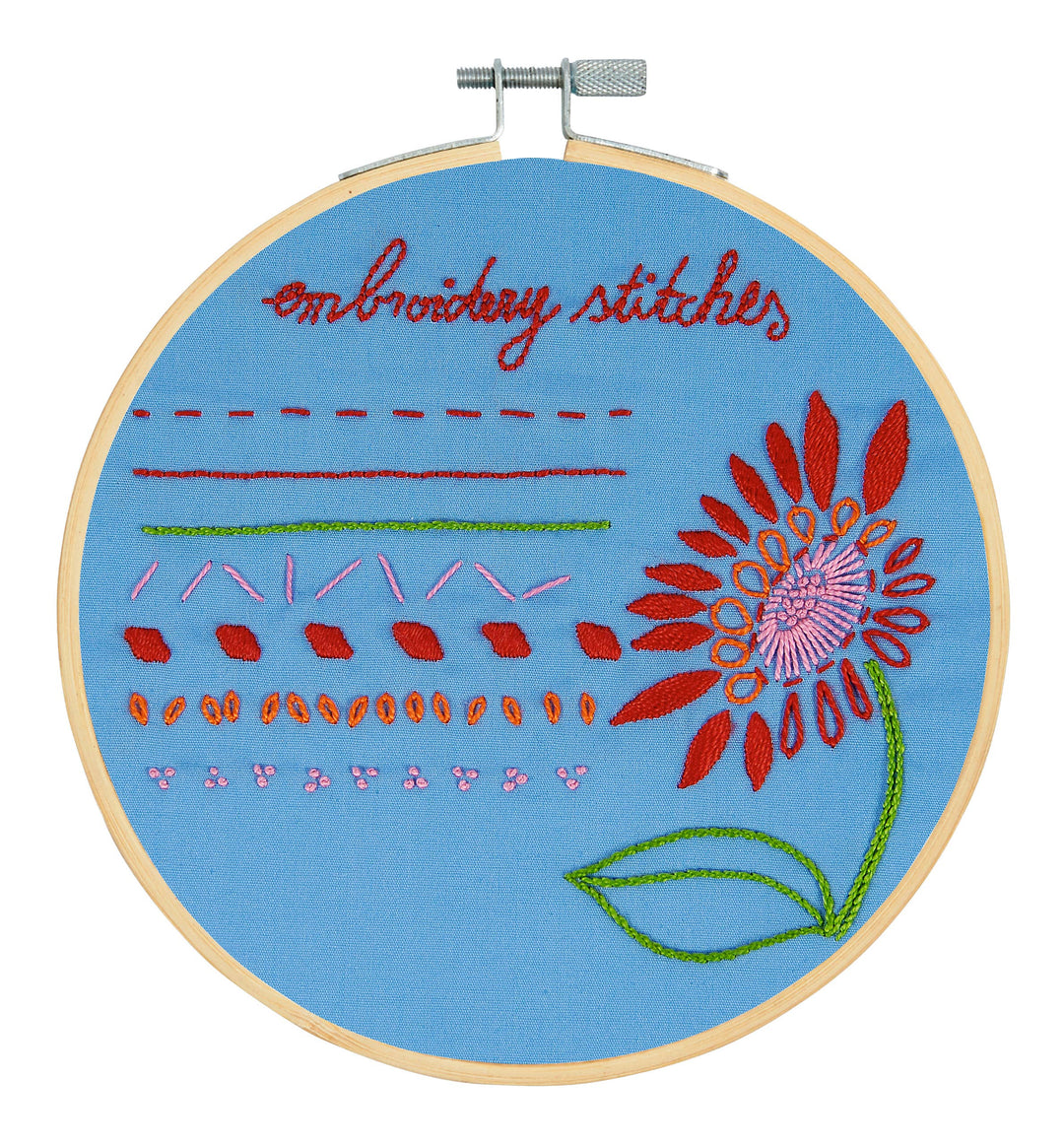 Embroidery hoop with floral design and text on a blue background