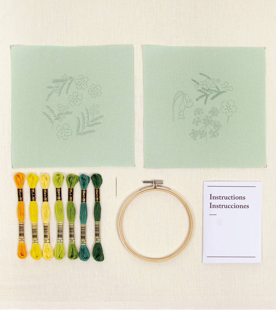 Embroidery kit with thread, hoop, and instructions on a light background