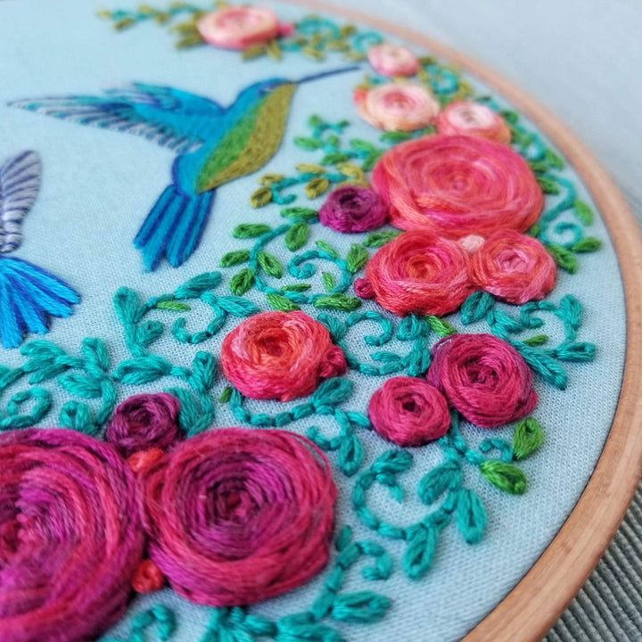 Embroidery hoop with colorful floral and bird design
