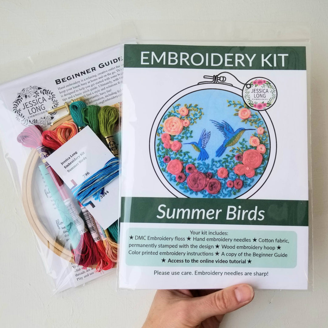Embroidery kit with 'Summer Birds' design and materials on a white background